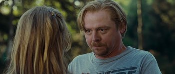 Movie still from “Paul” (2011), directed by Greg Mottola – A person with long blonde hair; Close Up shot, Over the shoulder angle