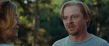 Movie still from “Paul” (2011), directed by Greg Mottola – A person wearing a gray shirt; Close Up shot, Over the shoulder angle