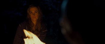 Movie still from “Paul” (2011), directed by Greg Mottola – A woman sitting in front of a fire at night; Close Up shot, Over the shoulder angle