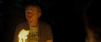 Movie still from “Paul” (2011), directed by Greg Mottola – A man with a beard is sitting in the dark; Medium shot, Over the shoulder angle