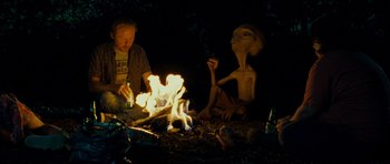 Movie still from “Paul” (2011), directed by Greg Mottola – Two people sitting around a fire at night; Medium shot, Over the shoulder angle