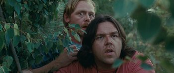Movie still from “Paul” (2011), directed by Greg Mottola – A man with a beard is holding another man's head; Close Up shot, Low angle