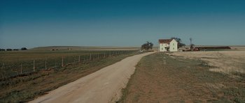 Movie still from “Paul” (2011), directed by Greg Mottola – A dirt road leading to a house on the side of the road; Extreme Wide shot, High angle