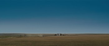 Movie still from “Paul” (2011), directed by Greg Mottola – An open field with a truck and a house in the distance; Extreme Wide shot, Low angle
