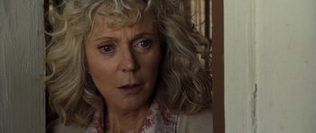 Movie still from “Paul” (2011), directed by Greg Mottola – An older woman with blonde curly hair looking at the camera; Close Up shot, Low angle