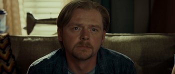 Movie still from “Paul” (2011), directed by Greg Mottola – A person sitting on a couch; Close Up shot, Over the shoulder angle