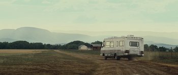 Movie still from “Paul” (2011), directed by Greg Mottola – An rv is parked on the side of a dirt road; Extreme Wide shot, Low angle