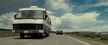 Movie still from “Paul” (2011), directed by Greg Mottola – A van and a car driving down a road; Wide shot, Low angle