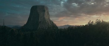 Movie still from “Paul” (2011), directed by Greg Mottola – A view of a large rock formation in the middle of a forest; Extreme Wide shot, Low angle