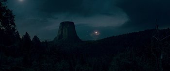 Movie still from “Paul” (2011), directed by Greg Mottola – A night time picture of devils tower in the distance; Extreme Wide shot, Low angle
