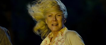 Movie still from “Paul” (2011), directed by Greg Mottola – An older woman with blonde hair and a floral print shirt; Close Up shot, Low angle