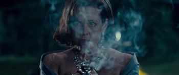 Movie still from “Paul” (2011), directed by Greg Mottola – A woman in a black dress smoking a cigarette; Close Up shot, Low angle