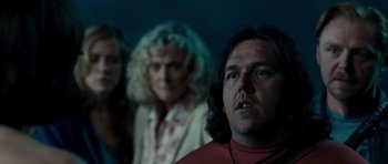 Movie still from “Paul” (2011), directed by Greg Mottola – Two women and a man in front of a blue wall; Close Up shot, Over the shoulder angle