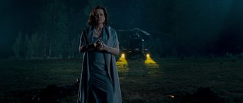 Movie still from “Paul” (2011), directed by Greg Mottola – A woman standing in front of a helicopter at night; Medium shot, Low angle