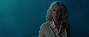 Movie still from “Paul” (2011), directed by Greg Mottola – A woman with blonde curly hair wearing a white jacket; Close Up shot, Low angle