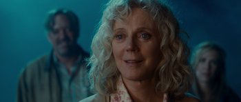 Movie still from “Paul” (2011), directed by Greg Mottola – An older woman with long blonde curly hair; Close Up shot, Over the shoulder angle