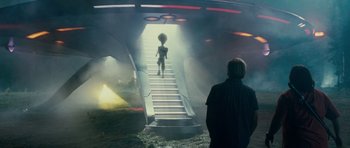 Movie still from “Paul” (2011), directed by Greg Mottola – An image of an alien walking down a stair way; Wide shot, Low angle