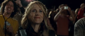 Movie still from “Paul” (2011), directed by Greg Mottola – A person smiling at a concert; Close Up shot, Over the shoulder angle