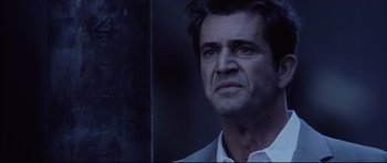 Movie still from “Payback” (1999), directed by Brian Helgeland – A person wearing a suit and tie; Close Up shot, Low angle