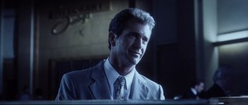 Movie still from “Payback” (1999), directed by Brian Helgeland – A person wearing a suit and tie; Close Up shot, Low angle