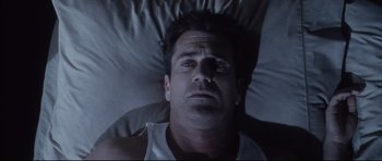 Movie still from “Payback” (1999), directed by Brian Helgeland – A person laying in a bed; Close Up shot, Overhead angle