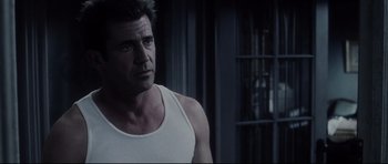 Movie still from “Payback” (1999), directed by Brian Helgeland – A person wearing a tank top; Close Up shot, Over the shoulder angle