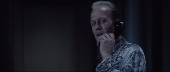 Movie still from “Payback” (1999), directed by Brian Helgeland – A man talking on a cell phone while holding his hand to his face; Close Up shot, Low angle