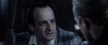 Movie still from “Payback” (1999), directed by Brian Helgeland – A person wearing a suit and tie; Close Up shot, Over the shoulder angle