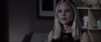 Movie still from “Payback” (1999), directed by Brian Helgeland – A beautiful blonde haired woman wearing a black dress; Close Up shot, Over the shoulder angle