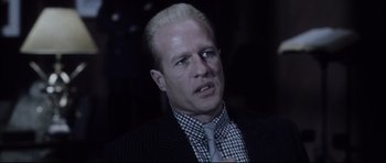 Movie still from “Payback” (1999), directed by Brian Helgeland – A man in a black suit and a tie; Close Up shot, Over the shoulder angle