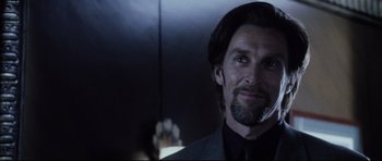 Movie still from “Payback” (1999), directed by Brian Helgeland – A person wearing a suit and holding a cell phone; Close Up shot, Over the shoulder angle