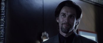 Movie still from “Payback” (1999), directed by Brian Helgeland – A person wearing a suit and tie; Close Up shot, Over the shoulder angle