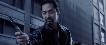 Movie still from “Payback” (1999), directed by Brian Helgeland – A person wearing a leather jacket; Close Up shot, Low angle