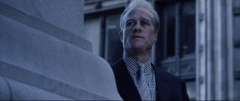 Movie still from “Payback” (1999), directed by Brian Helgeland – A man in a suit and tie looking up; Close Up shot, Low angle
