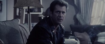 Movie still from “Payback” (1999), directed by Brian Helgeland – A person wearing a leather jacket; Close Up shot, Over the shoulder angle