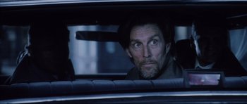 Movie still from “Payback” (1999), directed by Brian Helgeland – A man in a car looking out of the window; Close Up shot, Over the shoulder angle