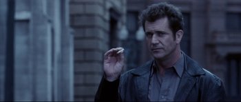 Movie still from “Payback” (1999), directed by Brian Helgeland – A man holding a cigarette in his hand; Close Up shot, Low angle