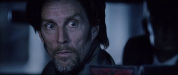 Movie still from “Payback” (1999), directed by Brian Helgeland – A person looking at the camera; Close Up shot, Low angle