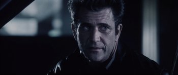 Movie still from “Payback” (1999), directed by Brian Helgeland – A person wearing a suit and tie; Close Up shot, Over the shoulder angle