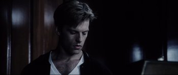 Movie still from “Payback” (1999), directed by Brian Helgeland – A young man with a beard is looking down at his face; Close Up shot, Low angle