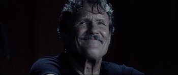 Movie still from “Payback” (1999), directed by Brian Helgeland – An older man with a mustache and a beard; Close Up shot, Low angle