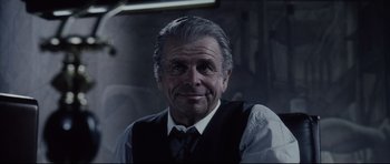 Movie still from “Payback” (1999), directed by Brian Helgeland – An older man wearing a vest and a tie; Close Up shot, Low angle