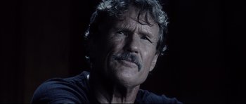 Movie still from “Payback” (1999), directed by Brian Helgeland – An older man with a mustache is looking at the camera; Close Up shot, Low angle