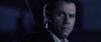 Movie still from “Payback” (1999), directed by Brian Helgeland – A person wearing a suit and tie; Close Up shot, Low angle