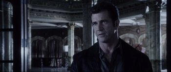 Movie still from “Payback” (1999), directed by Brian Helgeland – A person wearing a suit and tie; Close Up shot, Over the shoulder angle