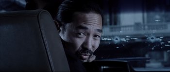 Movie still from “Payback” (1999), directed by Brian Helgeland – A person sitting in a car; Close Up shot, Over the shoulder angle