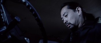 Movie still from “Payback” (1999), directed by Brian Helgeland – A man is looking at his cell phone in the dark; Close Up shot, Low angle