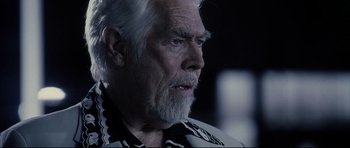 Movie still from “Payback” (1999), directed by Brian Helgeland – An older man with a gray beard looking into the distance; Close Up shot, Over the shoulder angle