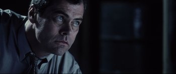 Movie still from “Payback” (1999), directed by Brian Helgeland – A person looking at the camera; Close Up shot, Low angle