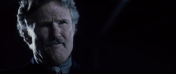 Movie still from “Payback” (1999), directed by Brian Helgeland – An older man with a mustache and a beard; Close Up shot, Low angle